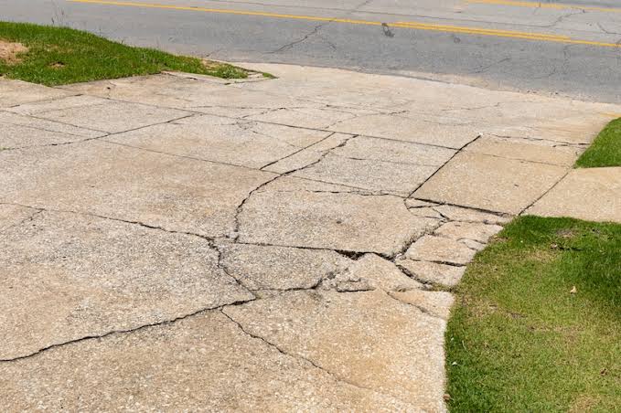 Cracked and damaged concrete driveway before replacement.